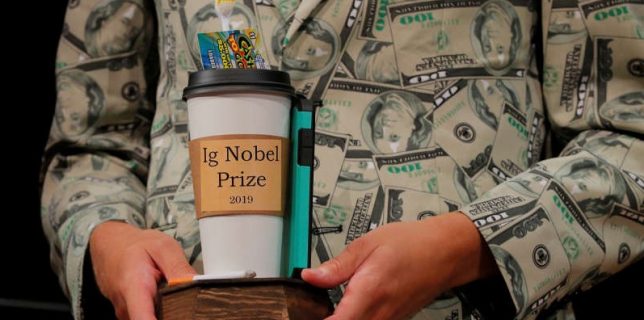 Timothy Voss holds the 2019 Ig Nobel Prize in Economics at the 29th First Annual Ig Nobel Prize Ceremony in Cambridge