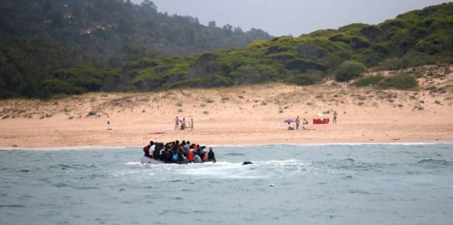 Migrants are seen before disembarking from a dinghy at „Del Canuelo” beach after they crossed the Strait of Gibraltar sailing from the coast of Morocco, in Tarifa